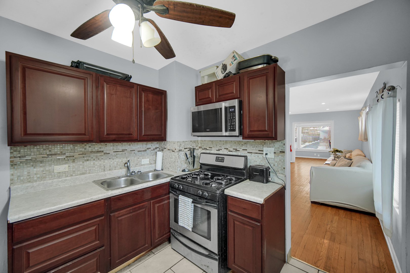 1635 Linden Road Homewood, IL 60430 - Photo 7 of 20 a kitchen with stainless steel appliances granite countertop a stove microwave and cabinets