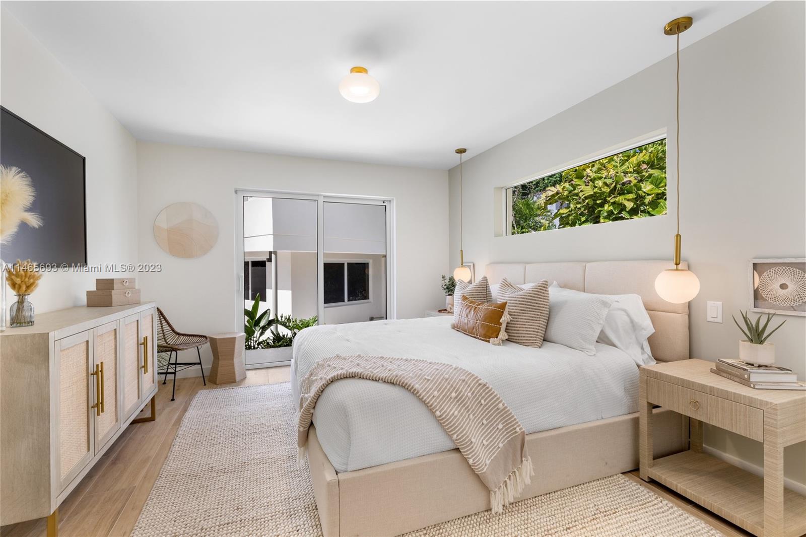 4160 Alton Road Miami Beach, FL 33140 - Photo 12 of 34 a bedroom with a bed and a chandelier
