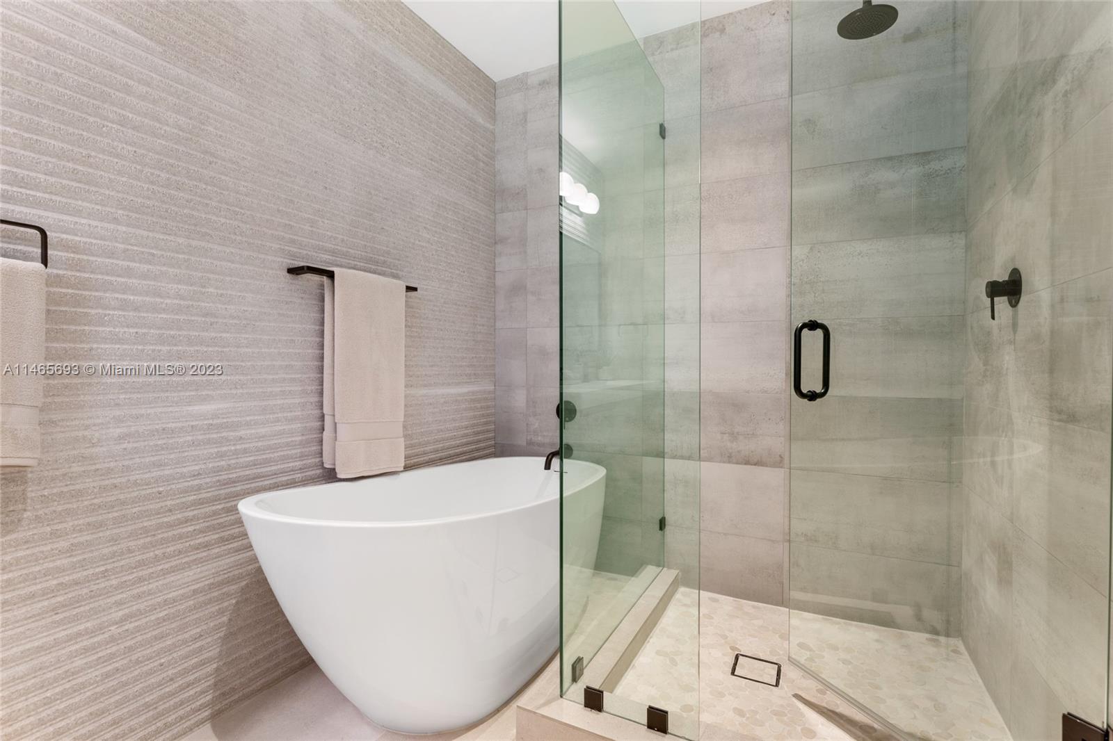 4160 Alton Road Miami Beach, FL 33140 - Photo 15 of 34 a bathroom with a sink and shower