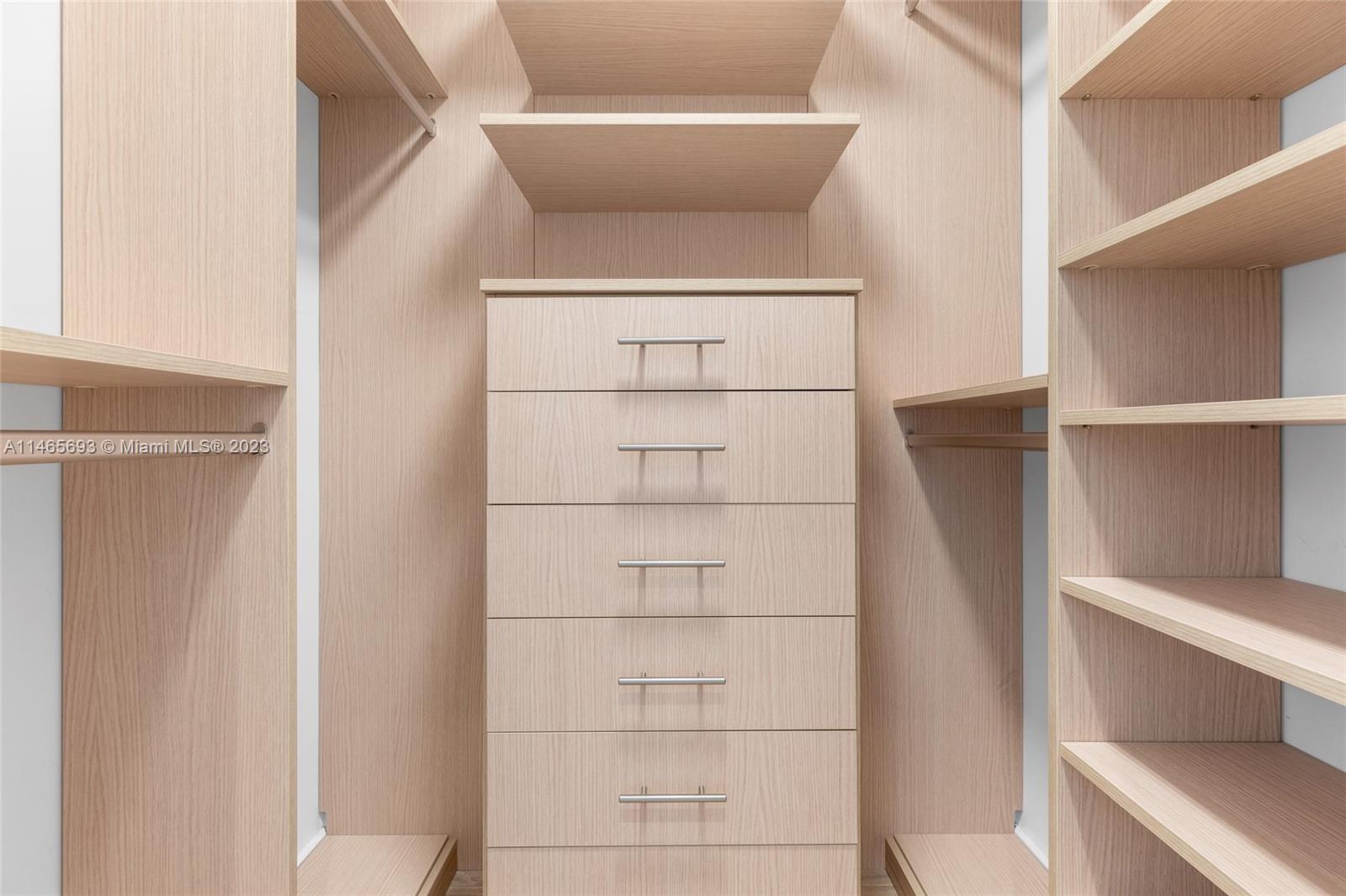4160 Alton Road Miami Beach, FL 33140 - Photo 16 of 34 a view of walk in closet with empty racks