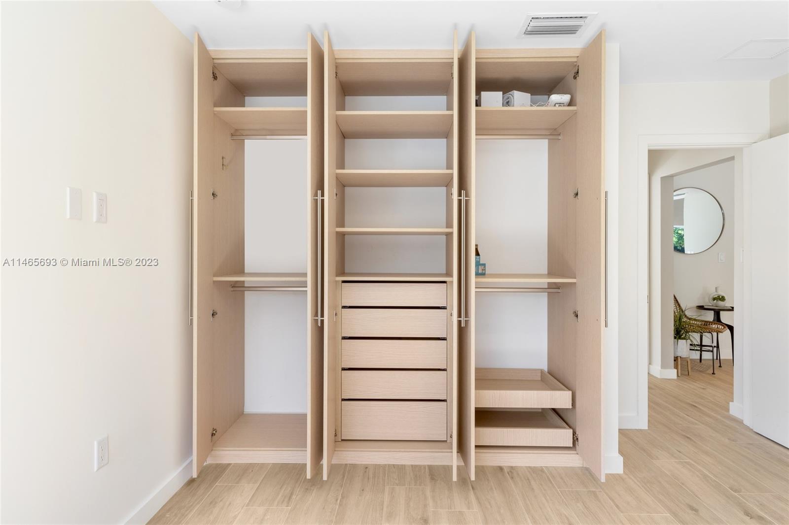 4160 Alton Road Miami Beach, FL 33140 - Photo 18 of 34 a view of walk in closet with empty racks