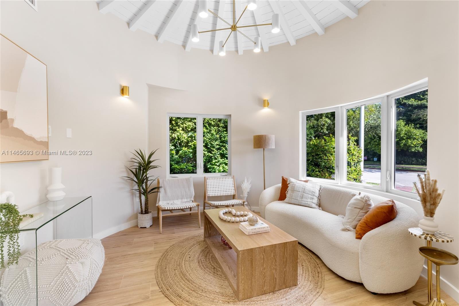 4160 Alton Road Miami Beach, FL 33140 - Photo 2 of 34 a living room with furniture and a large window