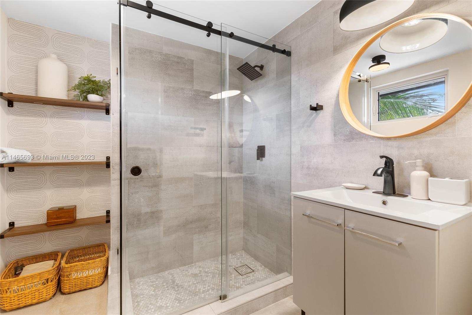 4160 Alton Road Miami Beach, FL 33140 - Photo 22 of 34 a bathroom with a sink and a mirror