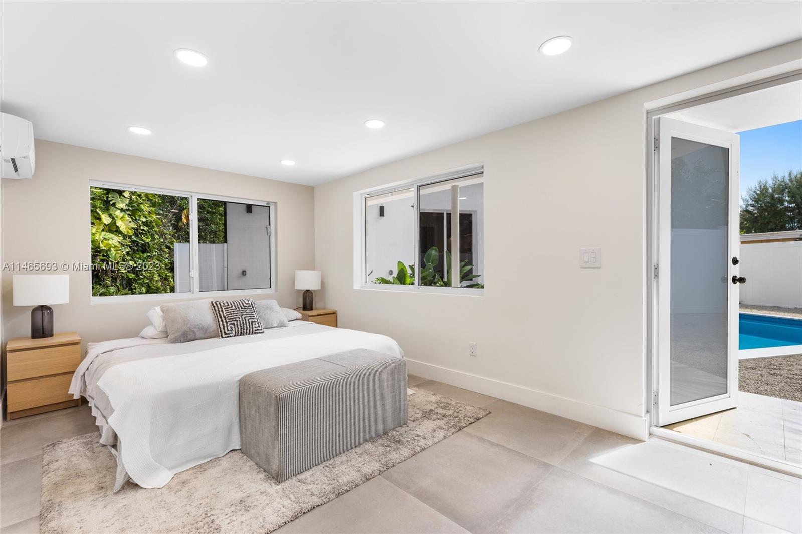 4160 Alton Road Miami Beach, FL 33140 - Photo 23 of 34 a bedroom with a large bed and a window