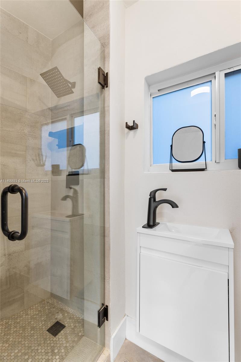 4160 Alton Road Miami Beach, FL 33140 - Photo 24 of 34 a bathroom with a sink a toilet and shower