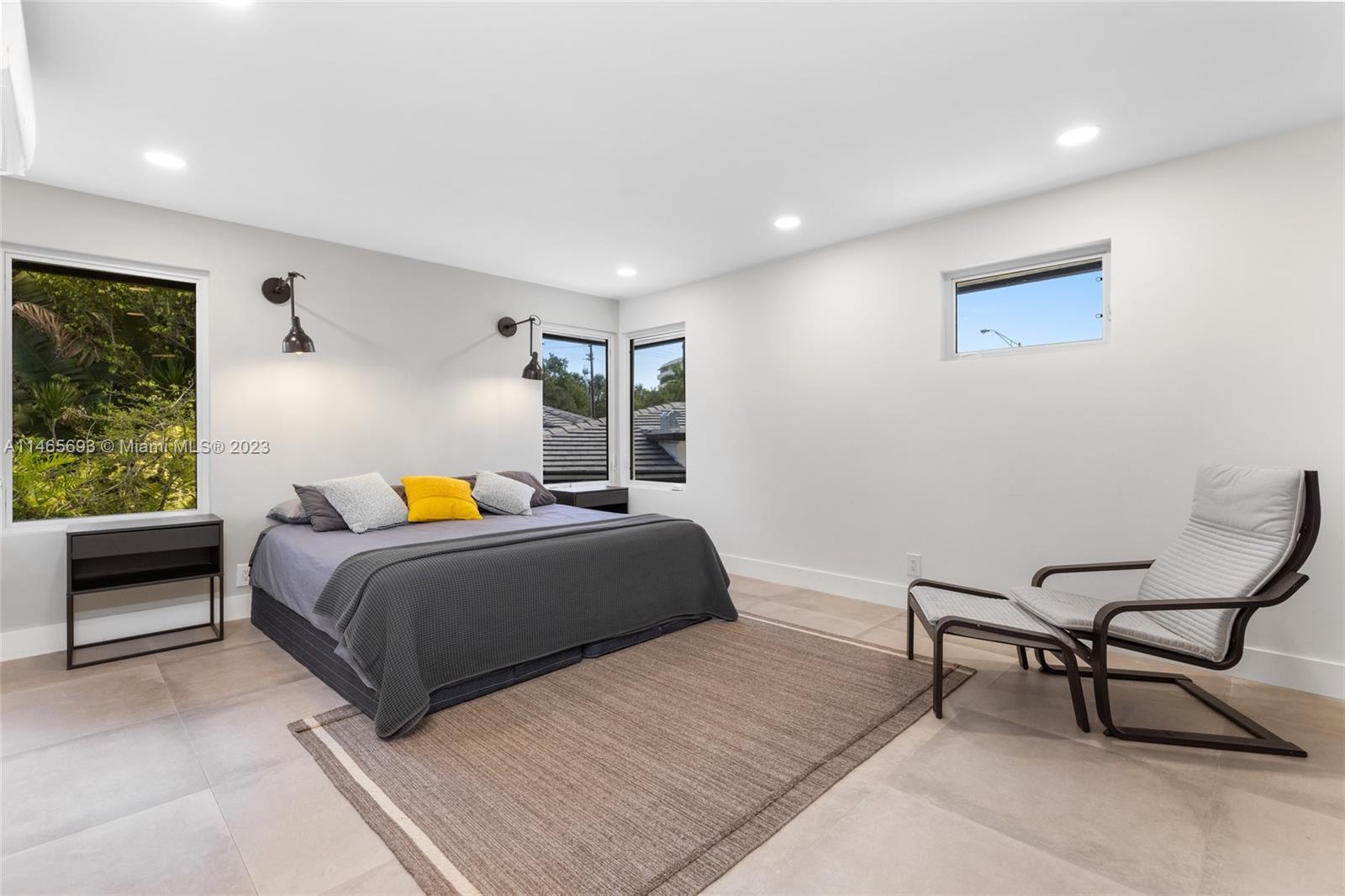 4160 Alton Road Miami Beach, FL 33140 - Photo 26 of 34 a bedroom with a bed and a window