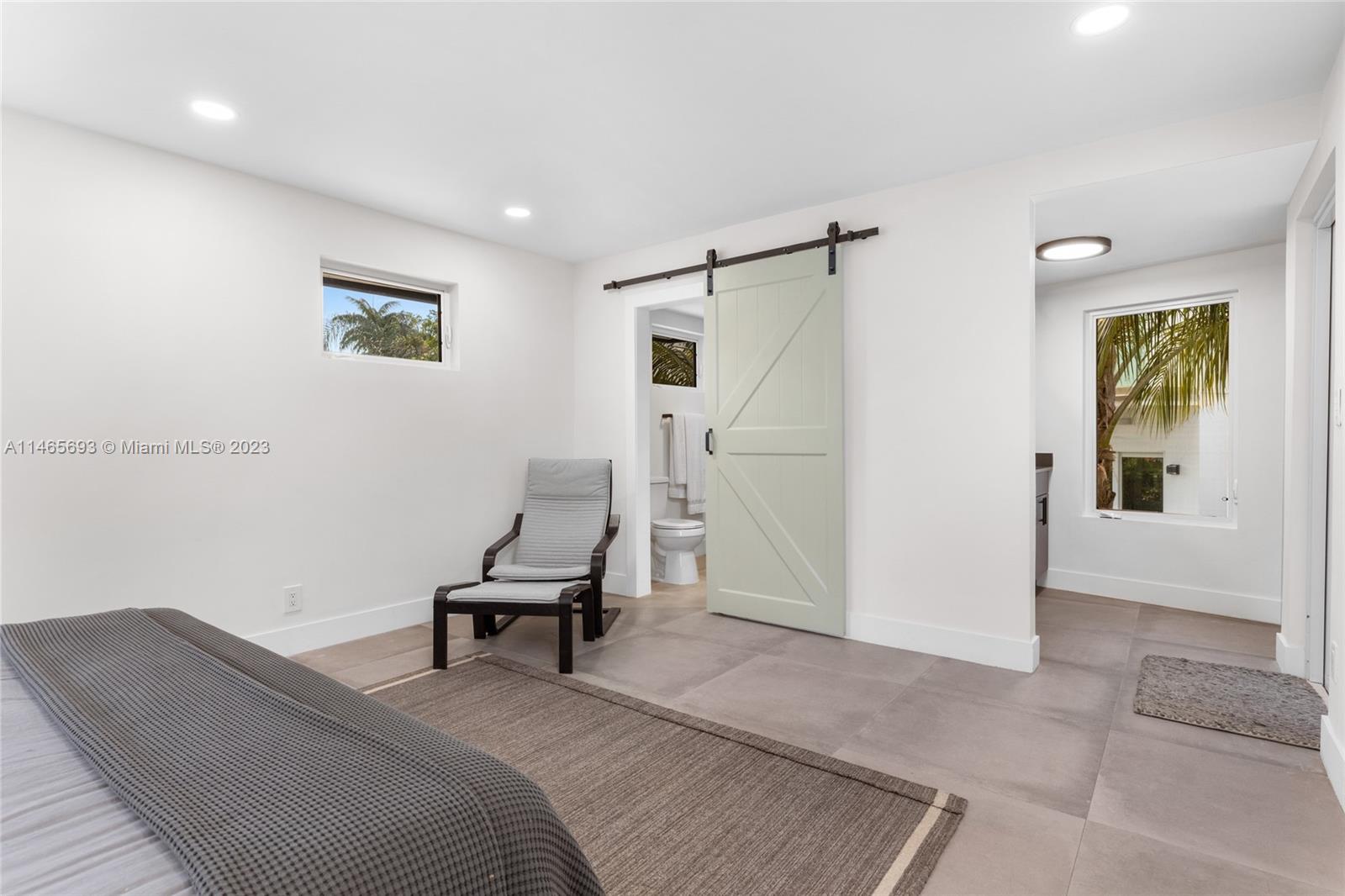 4160 Alton Road Miami Beach, FL 33140 - Photo 27 of 34 a bedroom with a bed and a window