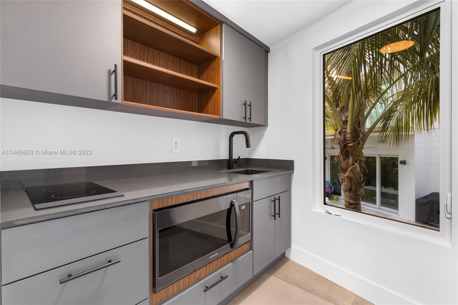4160 Alton Road Miami Beach, FL 33140 - Photo 28 of 34 a kitchen with a stove and a microwave