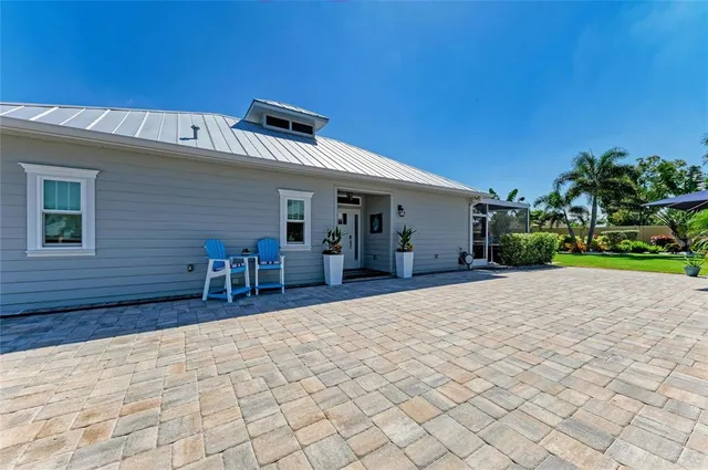 a living room with furniture a dining table and chairs with wooden floor