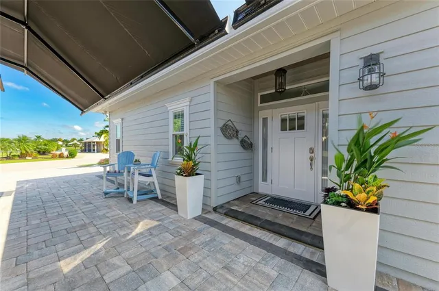 a large kitchen with stainless steel appliances a stove a sink dishwasher a dining table and chairs with wooden floor