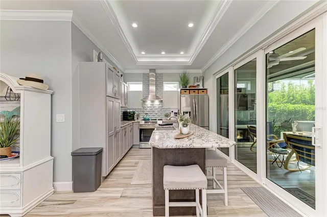 a bedroom with a white bed and a chandelier