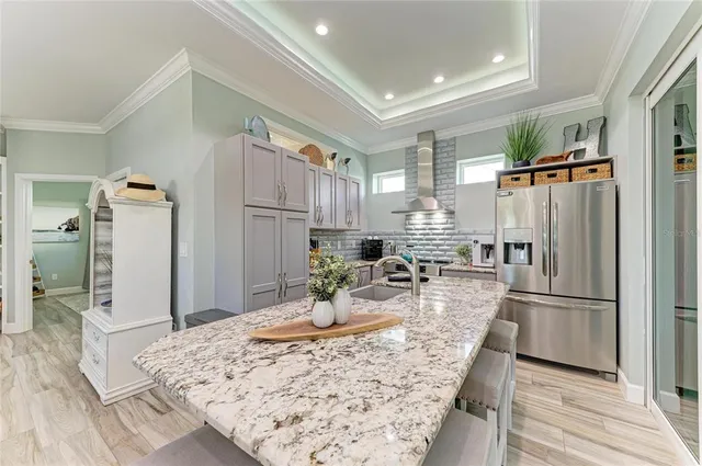 a bedroom with a bed and a lamp on dresser