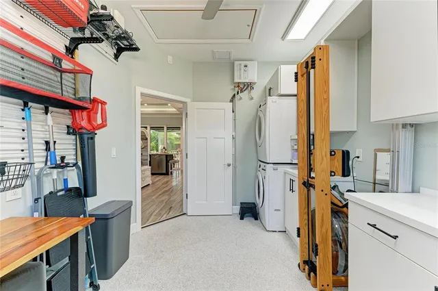 an aerial view of a house with a garden and lake view