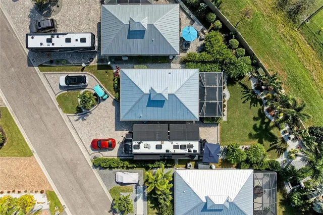 an aerial view of a house with swimming pool and outdoor space