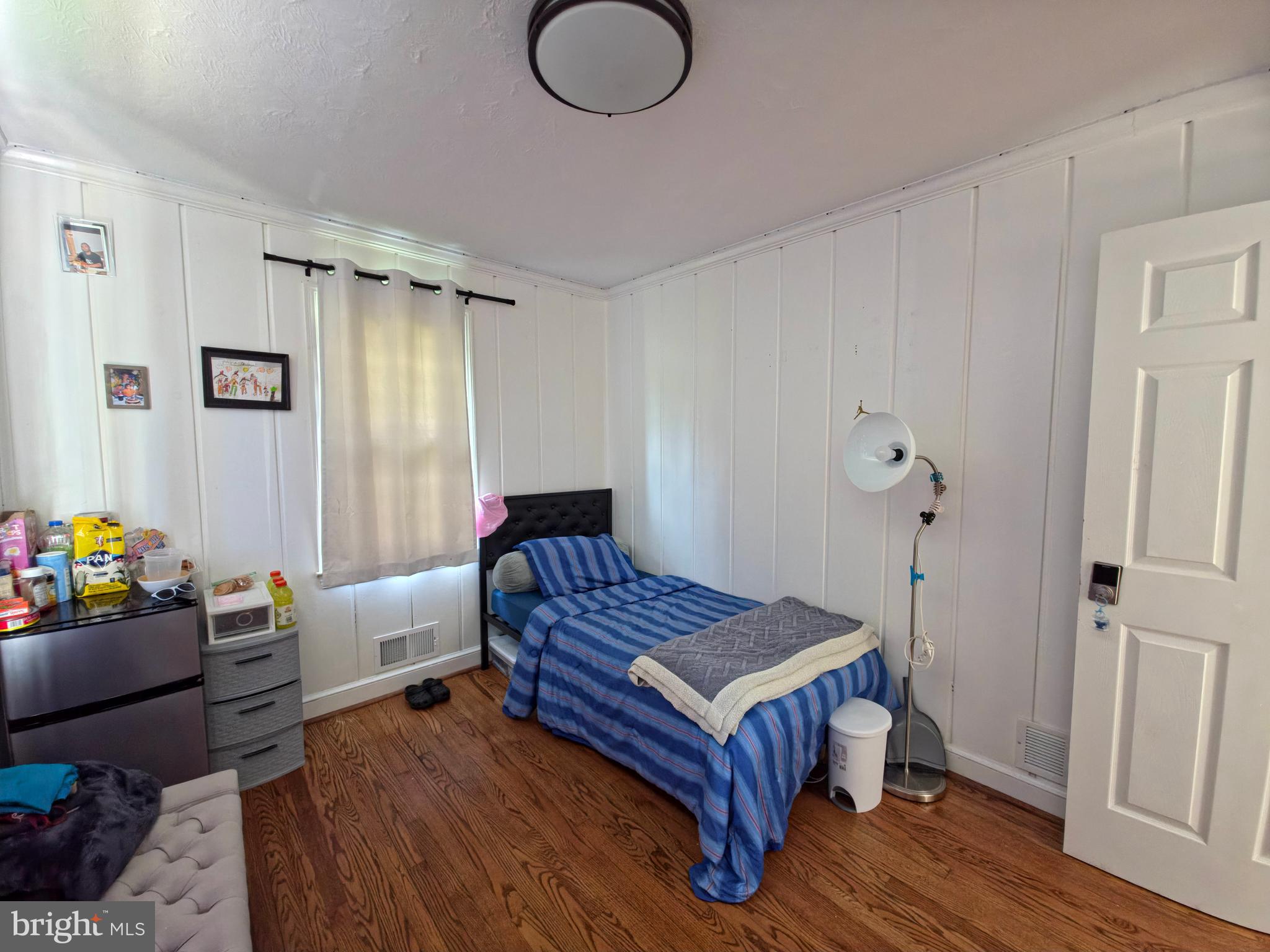 7450 Bensville Road Waldorf, MD 20603 - Photo 18 of 41 a bedroom with a bed and wooden floor