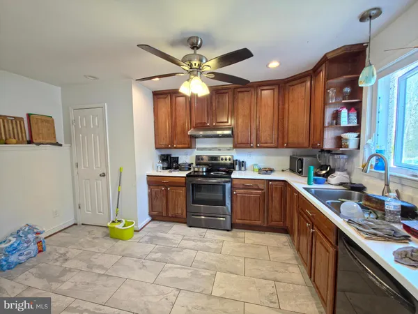 a kitchen with a stove cabinets and a sink