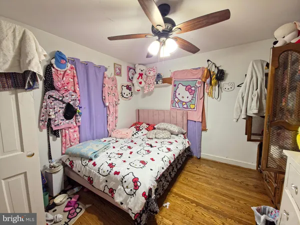 a bedroom with bed and a chandelier