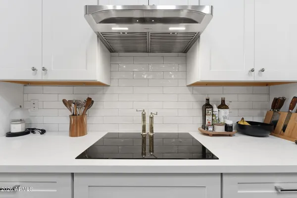 a kitchen with kitchen island a table and chairs in it