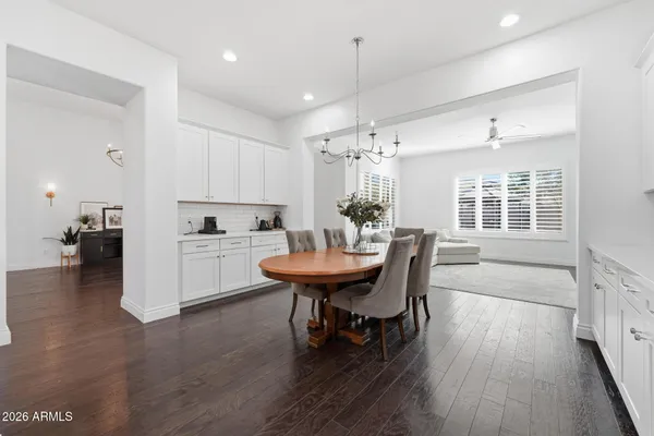 a view of a livingroom with furniture wooden floor chandelier