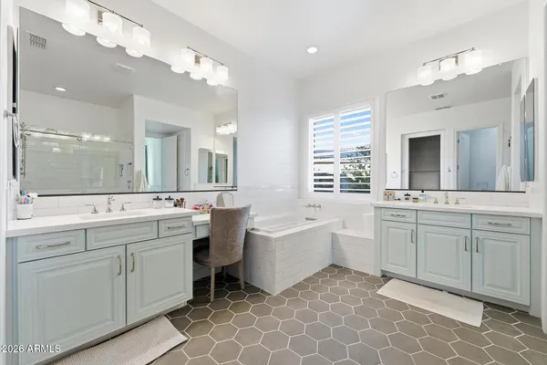 a bathroom with a granite countertop sink a mirror and a potted plant