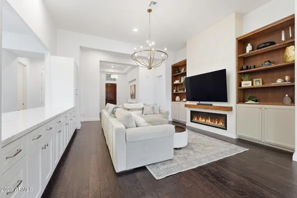 a living room with fireplace furniture and a flat screen tv