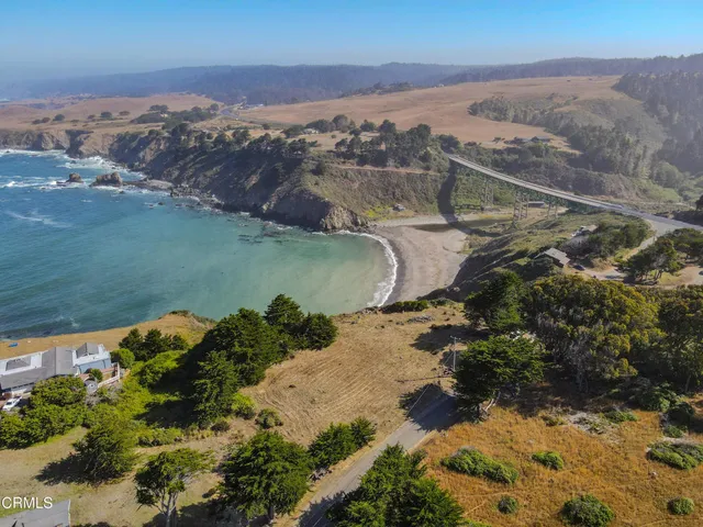 an aerial view of a houses with a lake view