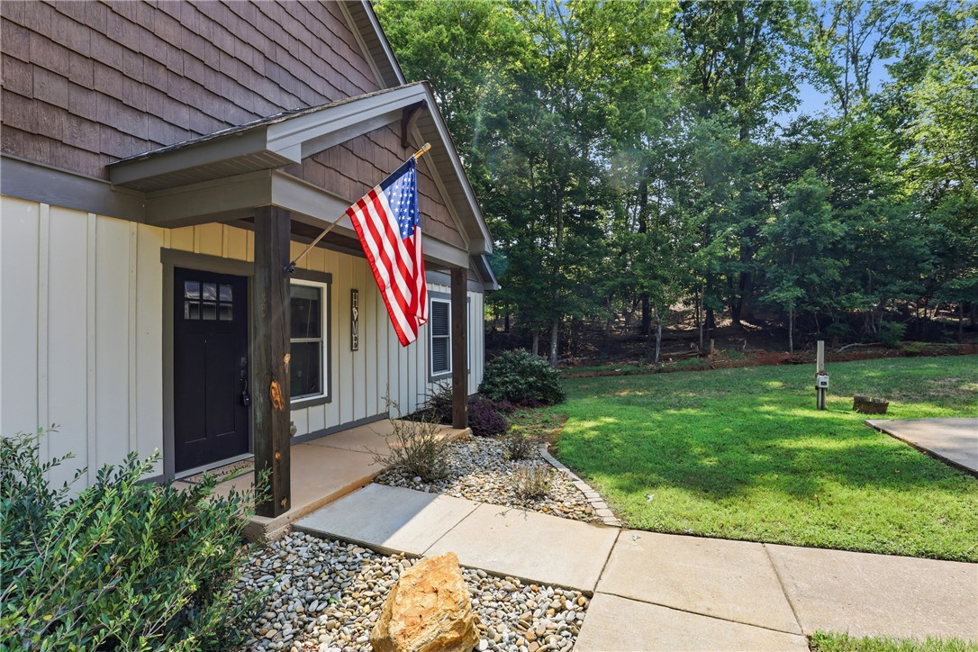 1110 Sunset Lane Anderson, SC 29626 - Photo 2 of 38 An inviting front porch welcomes you, framed by natural landscaping and mature trees for privacy.