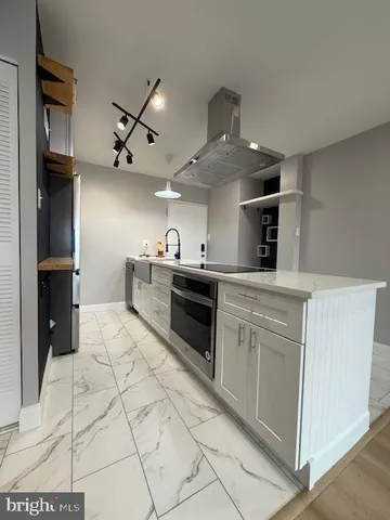 a kitchen with stainless steel appliances granite countertop a sink and cabinets