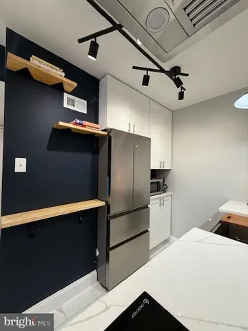 a kitchen with stainless steel appliances a refrigerator and a stove