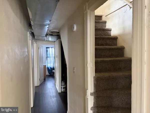 a view of a hallway with wooden floor and entryway