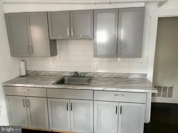 a kitchen with stainless steel appliances granite countertop a sink a stove and a microwave
