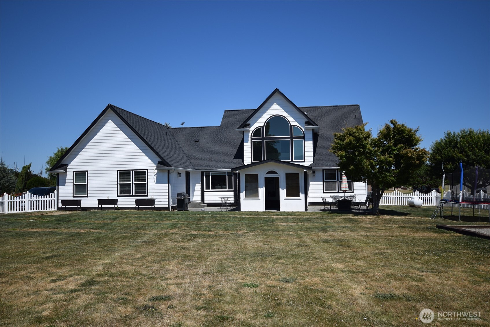 71 John Carl Road Sequim, WA 98382 - Photo 2 of 37 a view of a house with a big yard and large trees