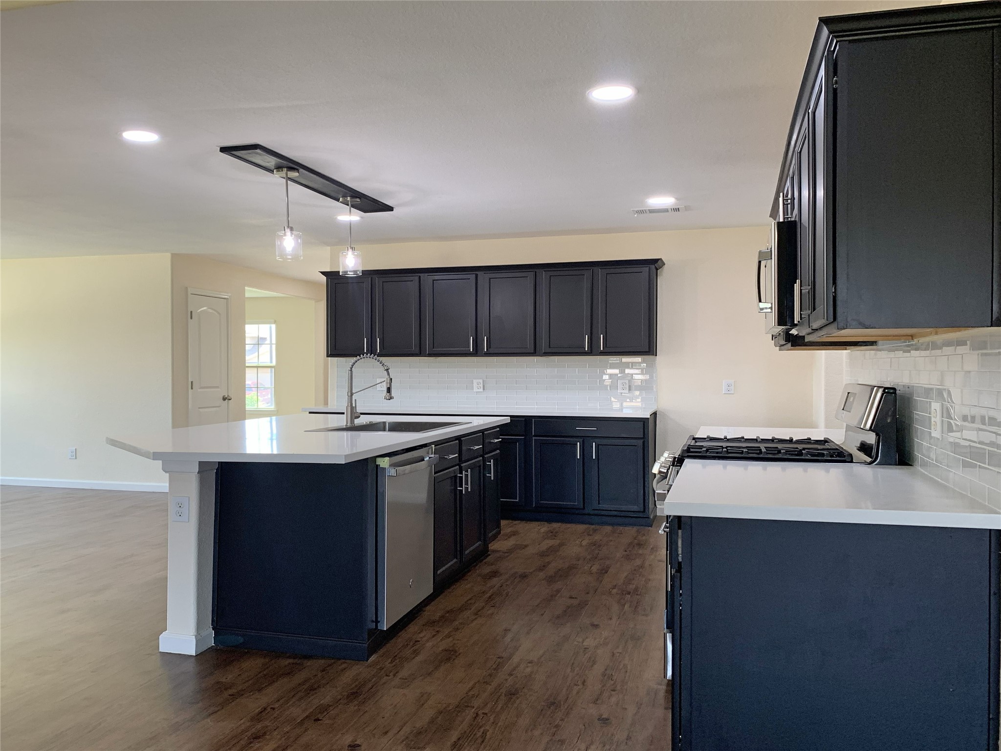 5612 Rainflower Terrace Lane Spring, TX 77389 - Photo 8 of 50 a kitchen with stainless steel appliances granite countertop a sink stove and microwave