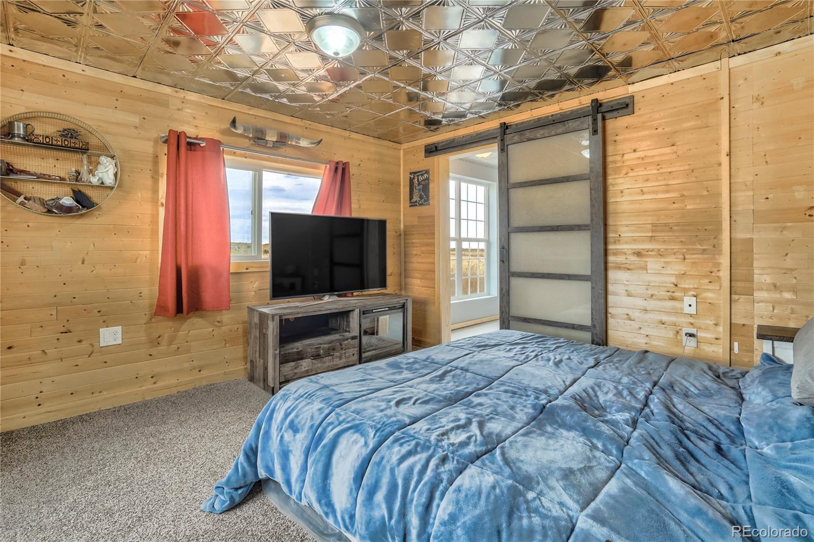 3549 County Road 650 Rye, CO 81069 - Photo 15 of 39 a bedroom with a bed and a flat screen tv