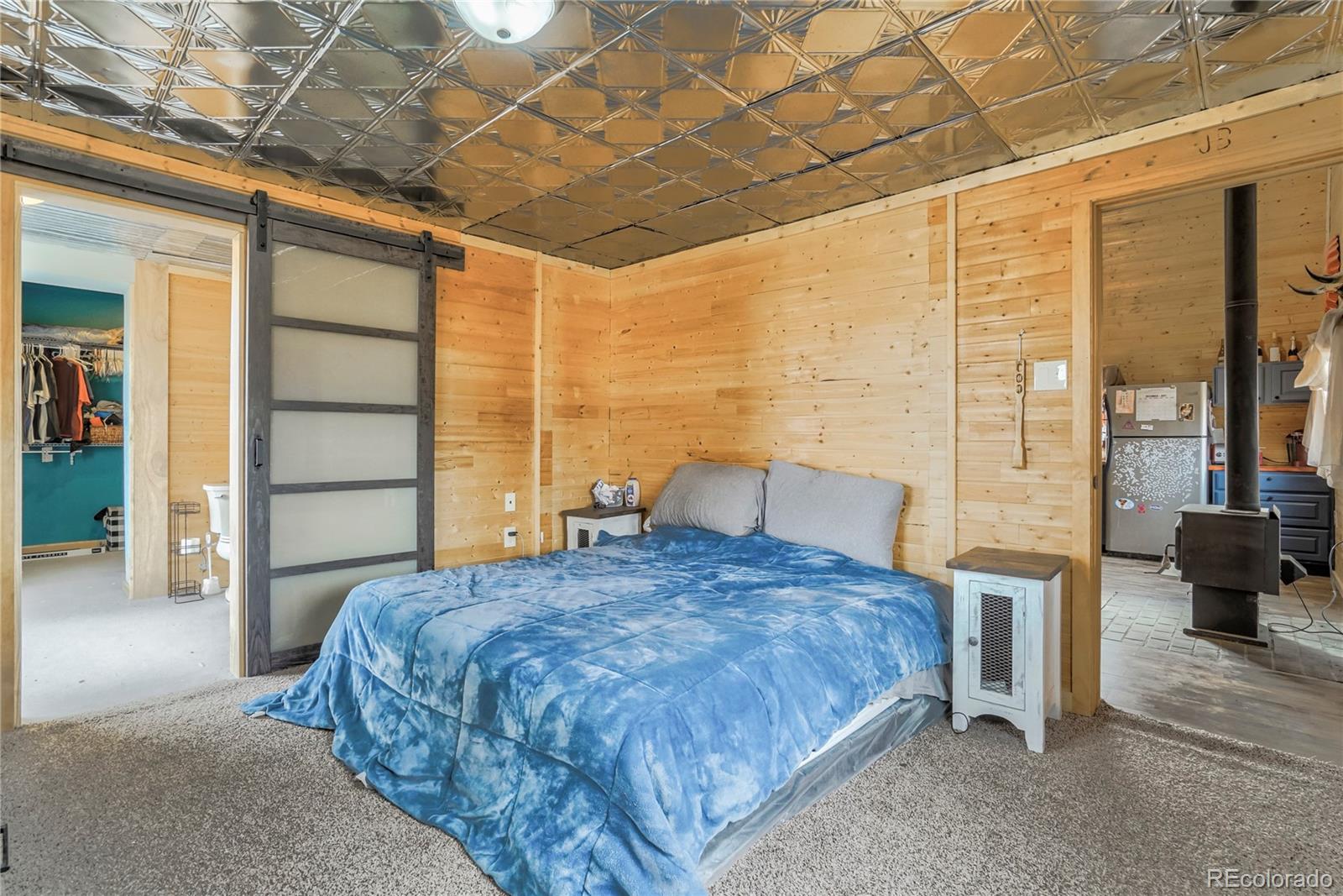 3549 County Road 650 Rye, CO 81069 - Photo 16 of 39 a bedroom with a large bed and a large window