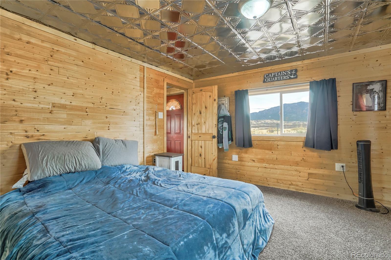 3549 County Road 650 Rye, CO 81069 - Photo 17 of 39 a bedroom with a bed and a large window