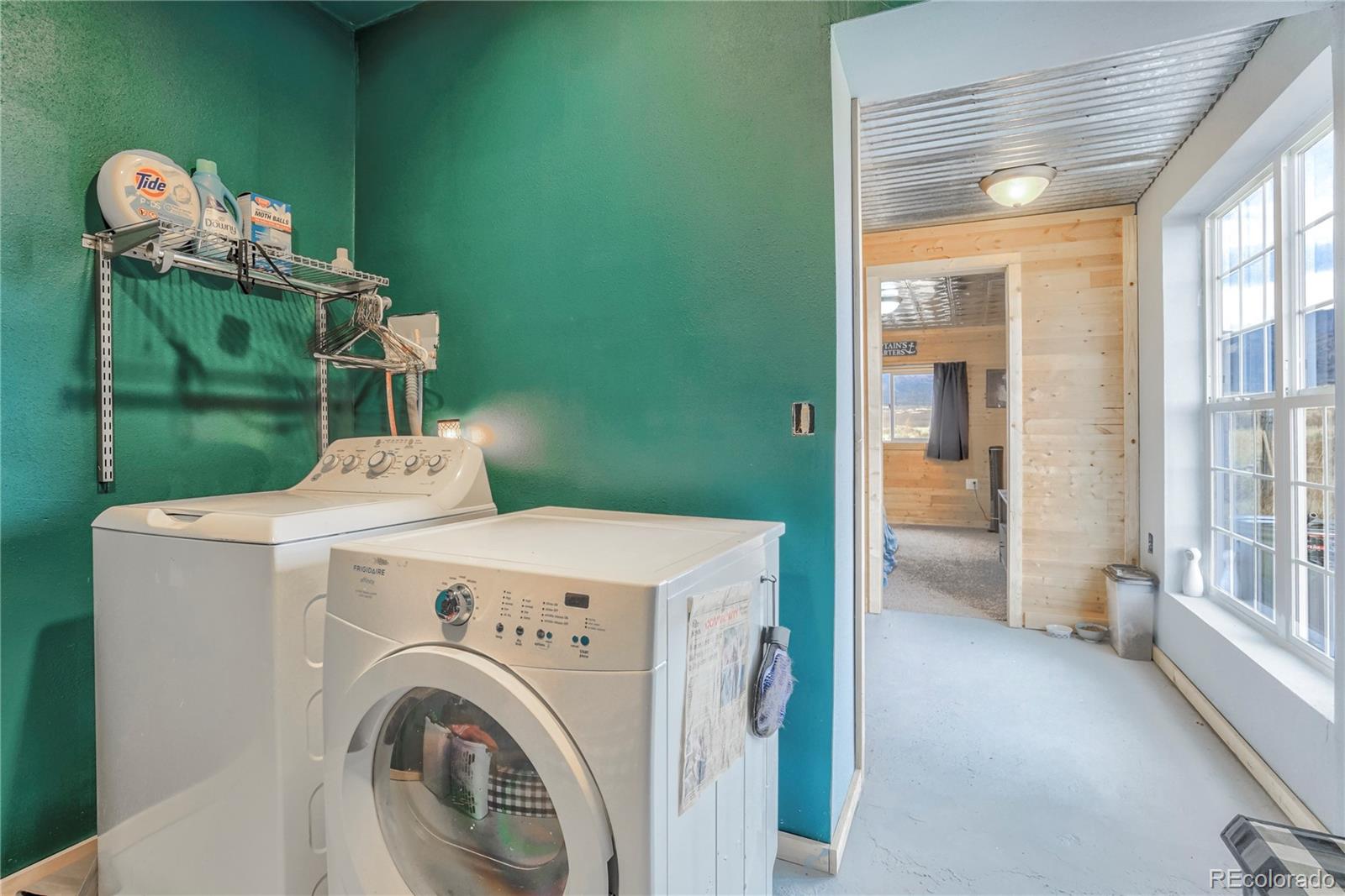 3549 County Road 650 Rye, CO 81069 - Photo 22 of 39 a view of washer and dryer with kitchen in the background