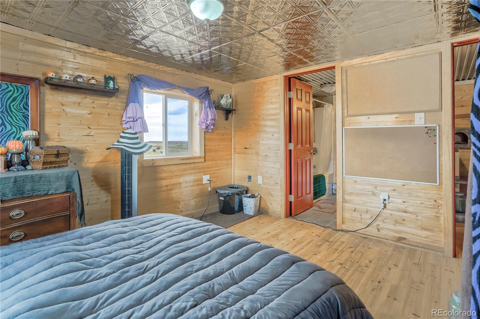 3549 County Road 650 Rye, CO 81069 - Photo 26 of 39 a bedroom with a bed and wooden floor