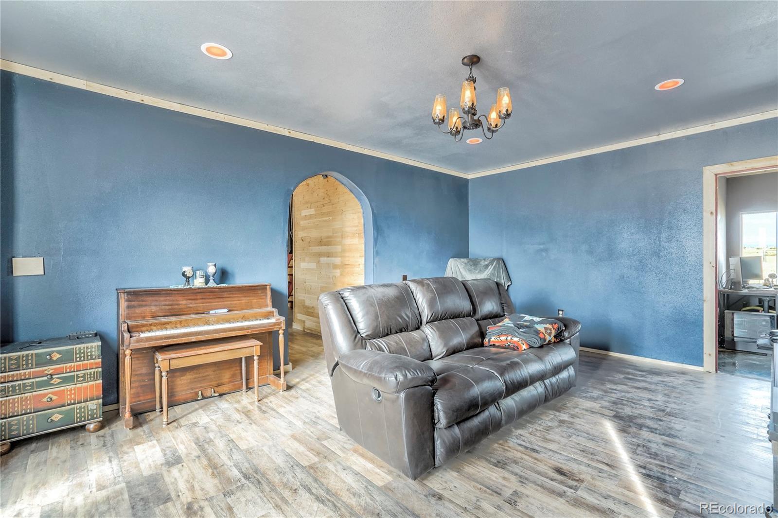 3549 County Road 650 Rye, CO 81069 - Photo 3 of 39 a living room with furniture and a chandelier
