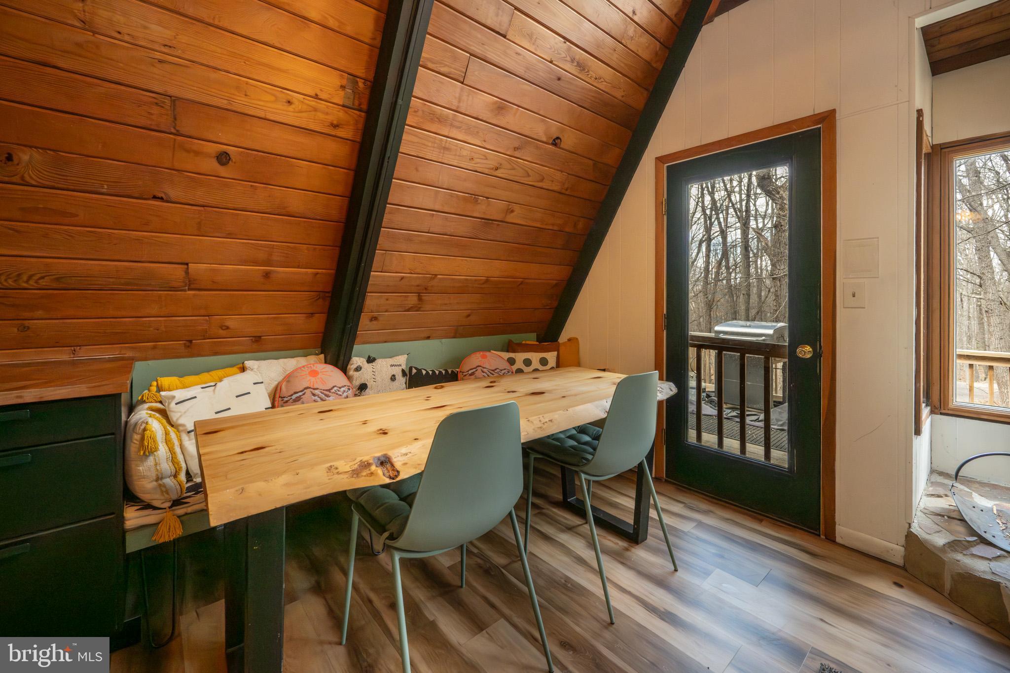 527 Deer Run Lane Swanton, MD 21561 - Photo 11 of 51 a view of a patio with table and chairs with wooden floor and fence