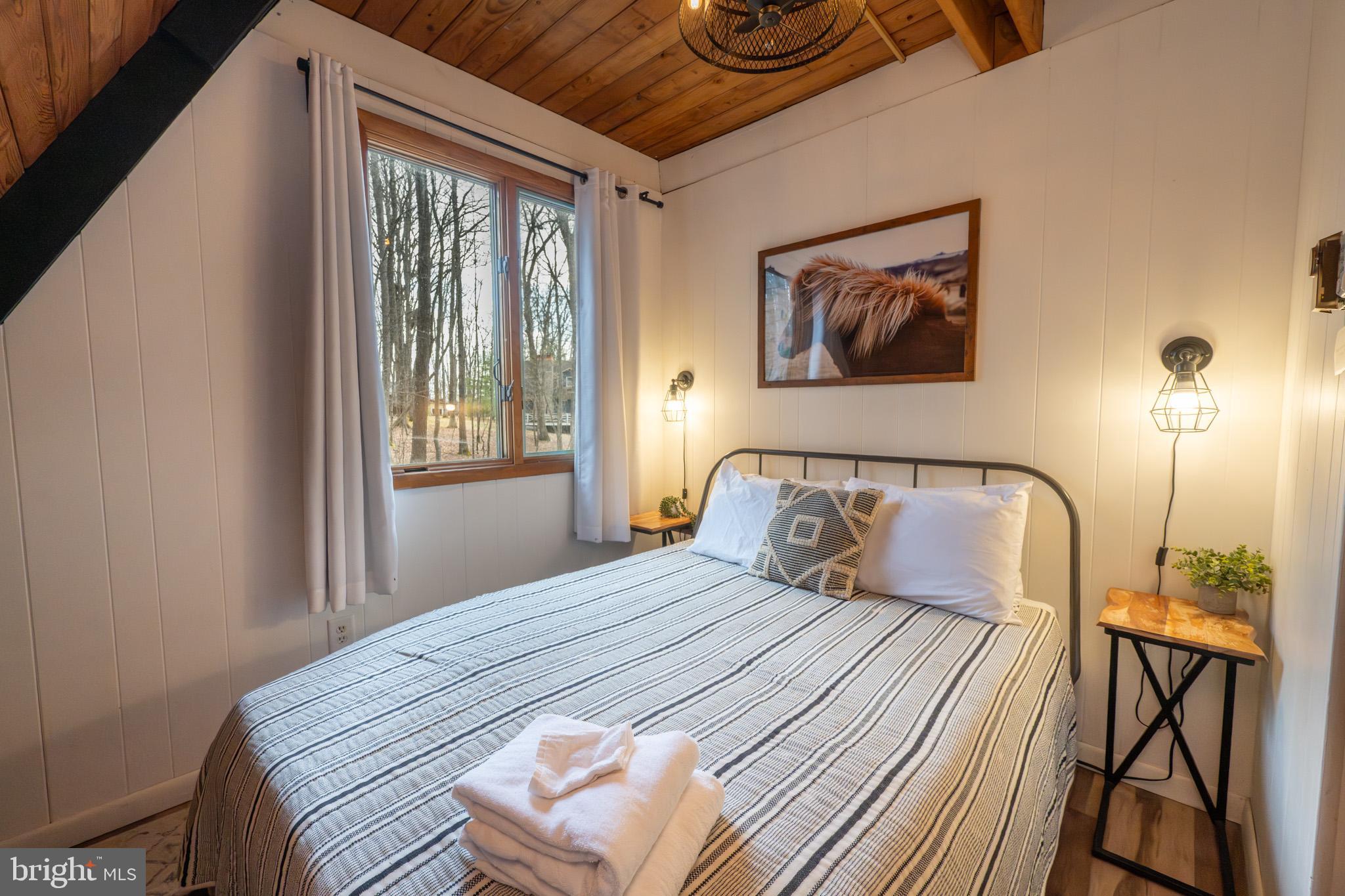 527 Deer Run Lane Swanton, MD 21561 - Photo 21 of 51 a bedroom with a bed and a window