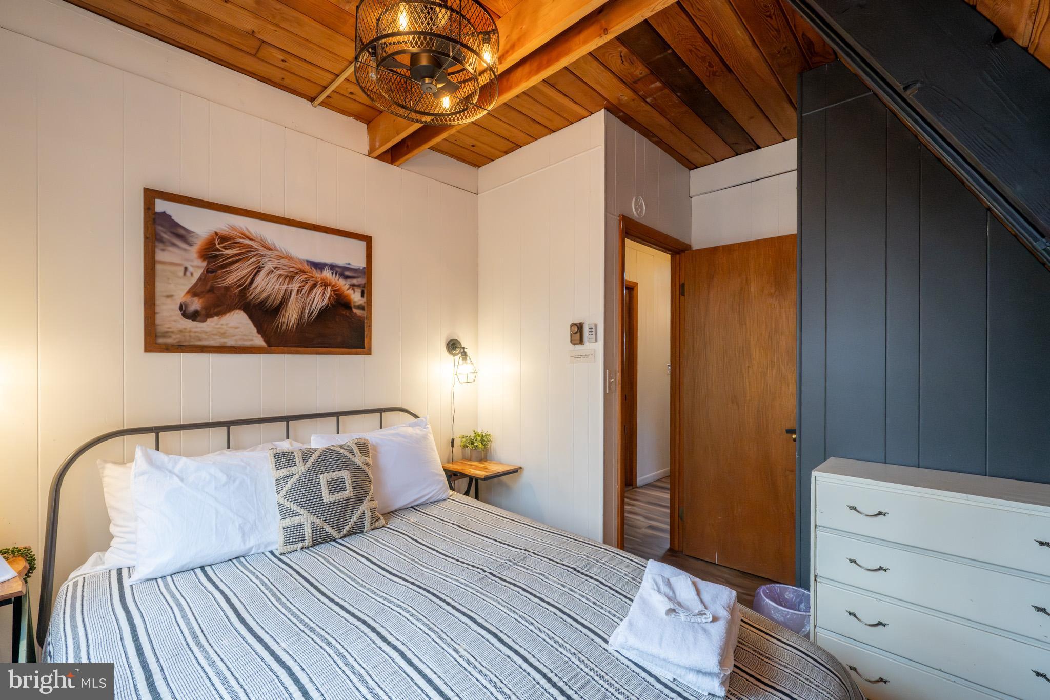 527 Deer Run Lane Swanton, MD 21561 - Photo 22 of 51 a bedroom with a bed and wooden floor
