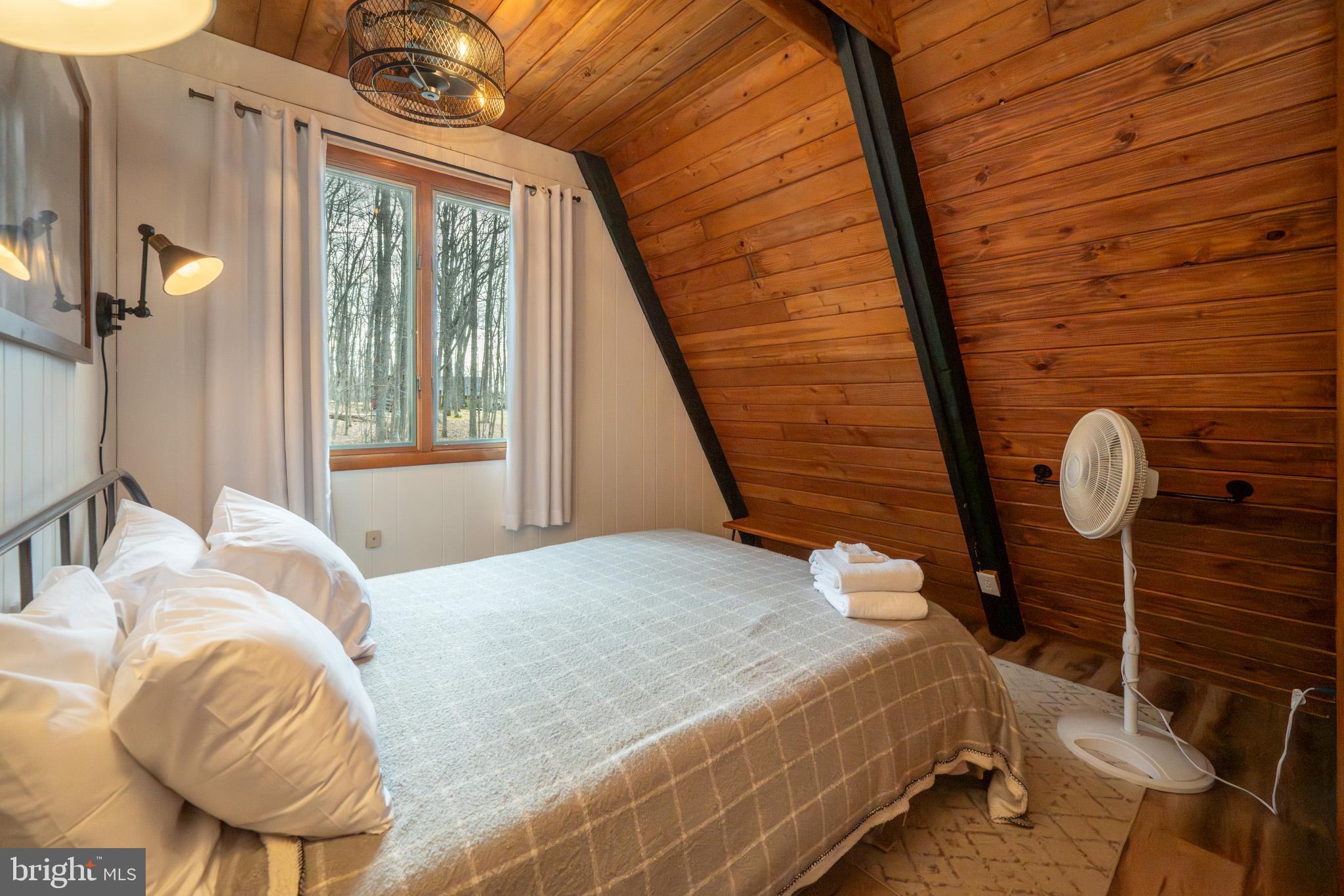 527 Deer Run Lane Swanton, MD 21561 - Photo 26 of 51 a bedroom with a bed and wooden floor