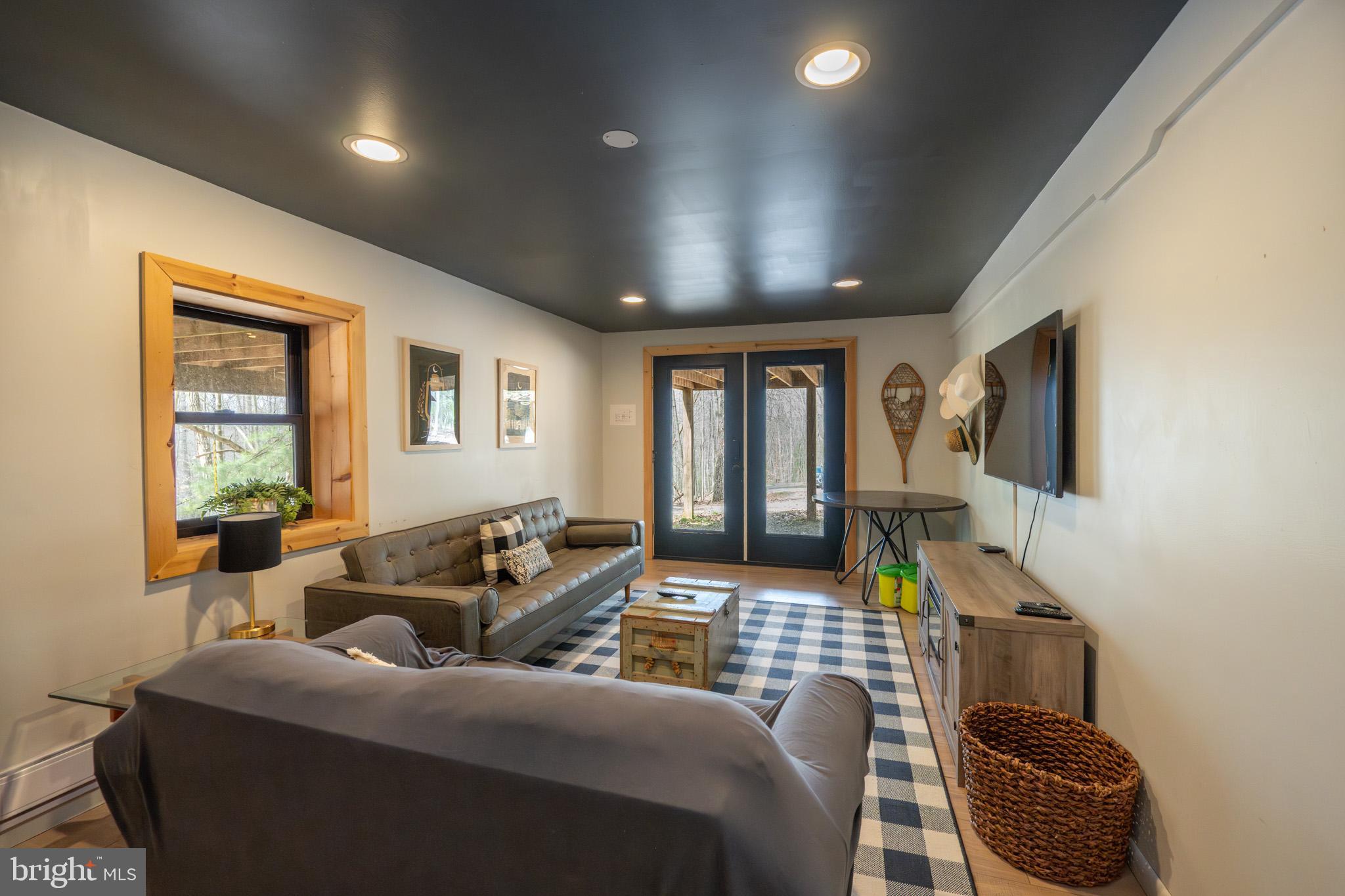 527 Deer Run Lane Swanton, MD 21561 - Photo 35 of 51 a living room with furniture and a flat screen tv