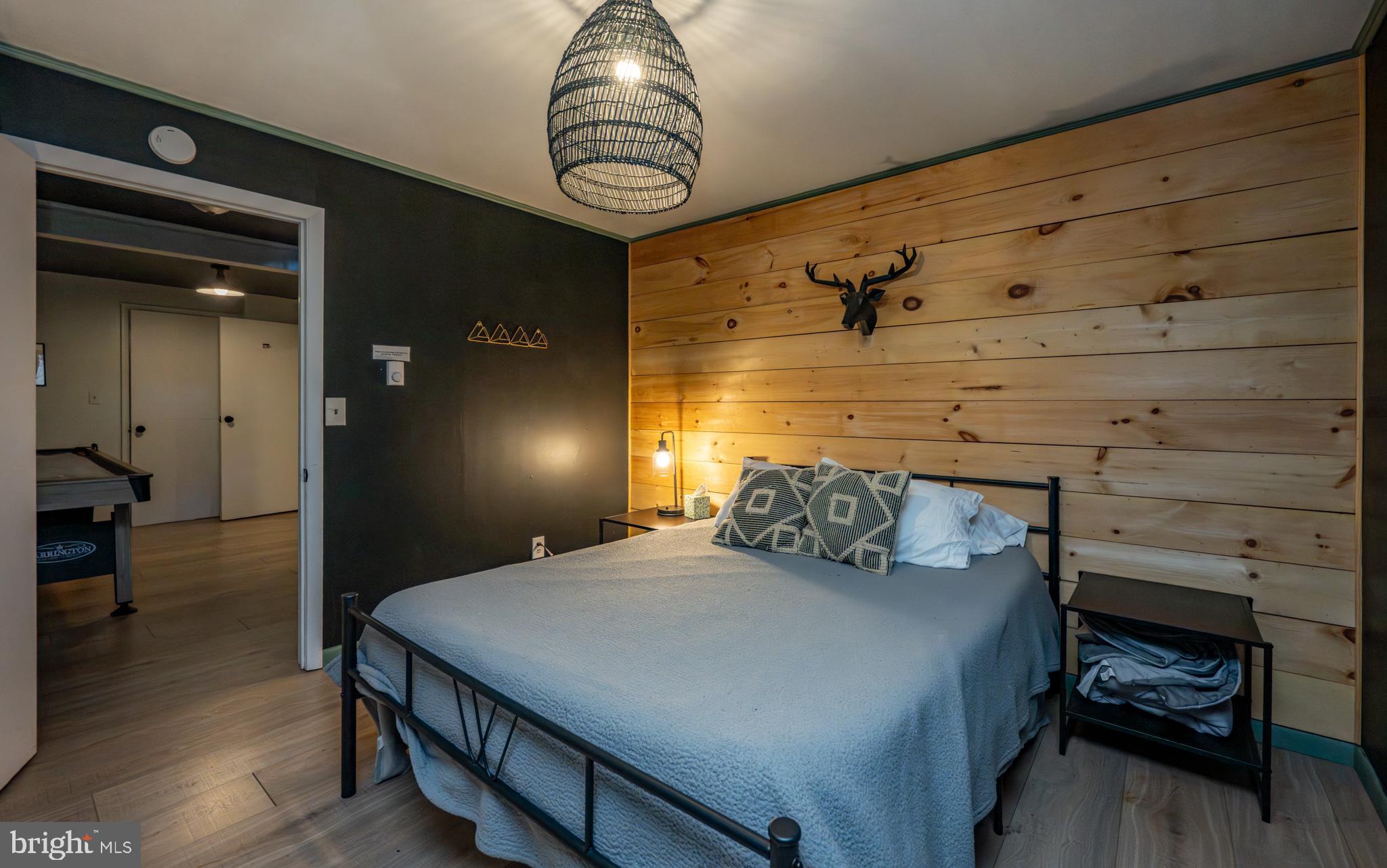 527 Deer Run Lane Swanton, MD 21561 - Photo 41 of 51 a bedroom with a bed and wooden floor
