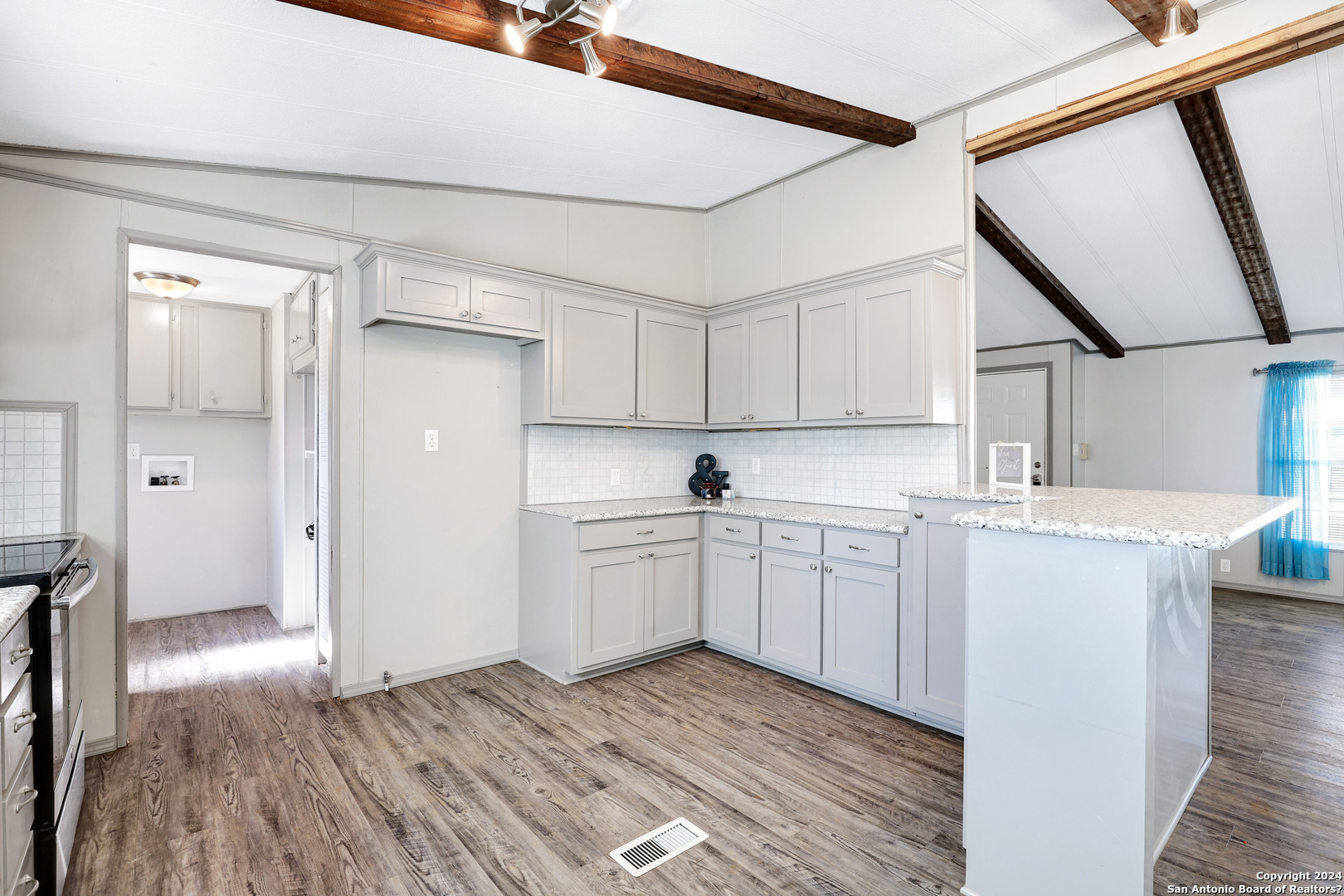 18066 La Gloria Road Elmendorf, TX 78112 - Photo 11 of 24 a kitchen with sink cabinets and wooden floor