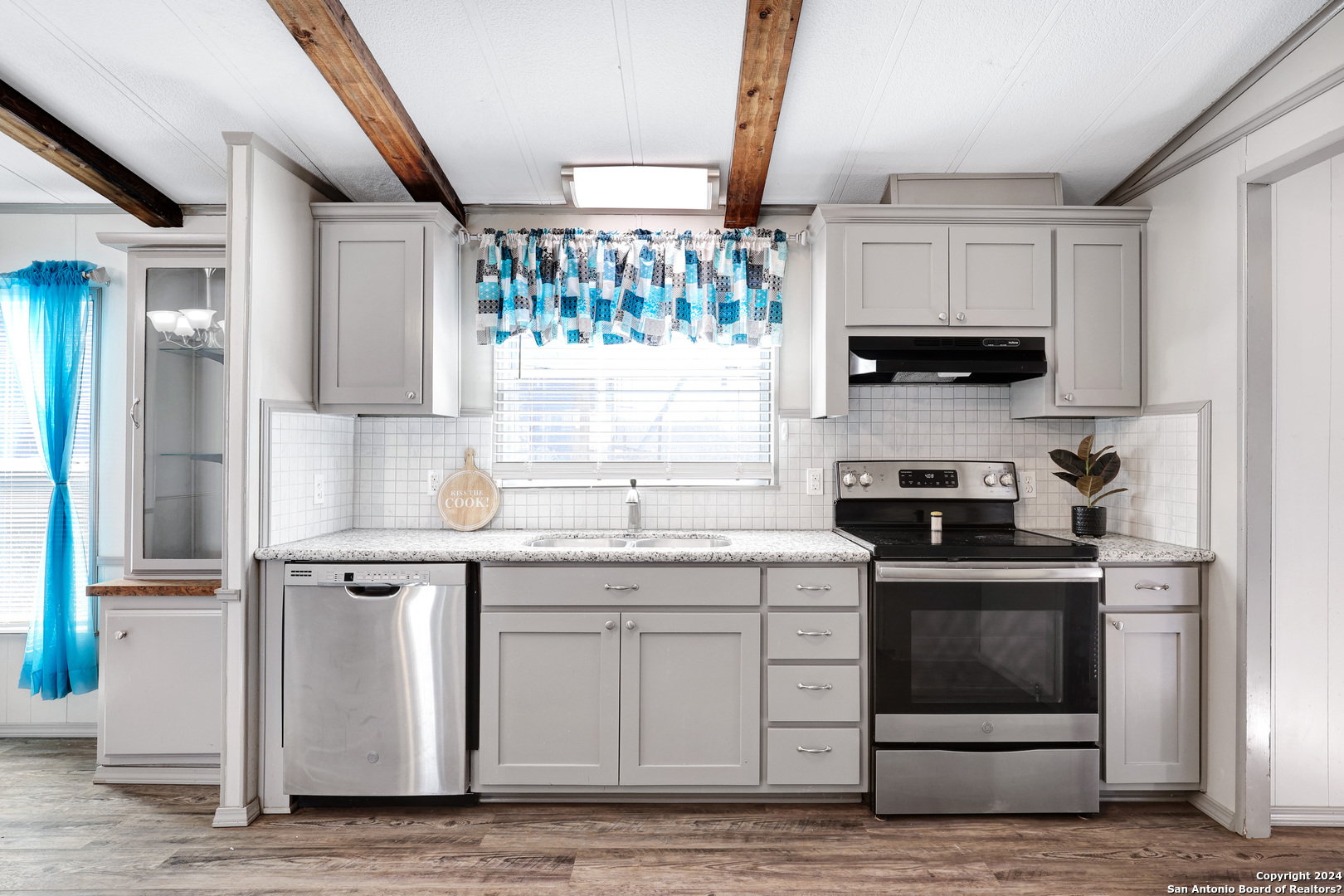 18066 La Gloria Road Elmendorf, TX 78112 - Photo 13 of 24 a kitchen with stainless steel appliances granite countertop a stove and a sink