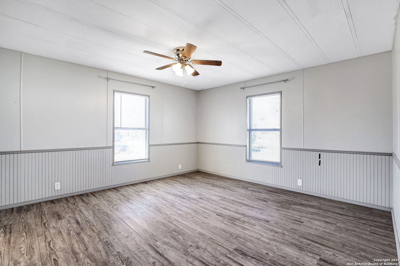 18066 La Gloria Road Elmendorf, TX 78112 - Photo 15 of 24 wooden floor in an empty room with a window