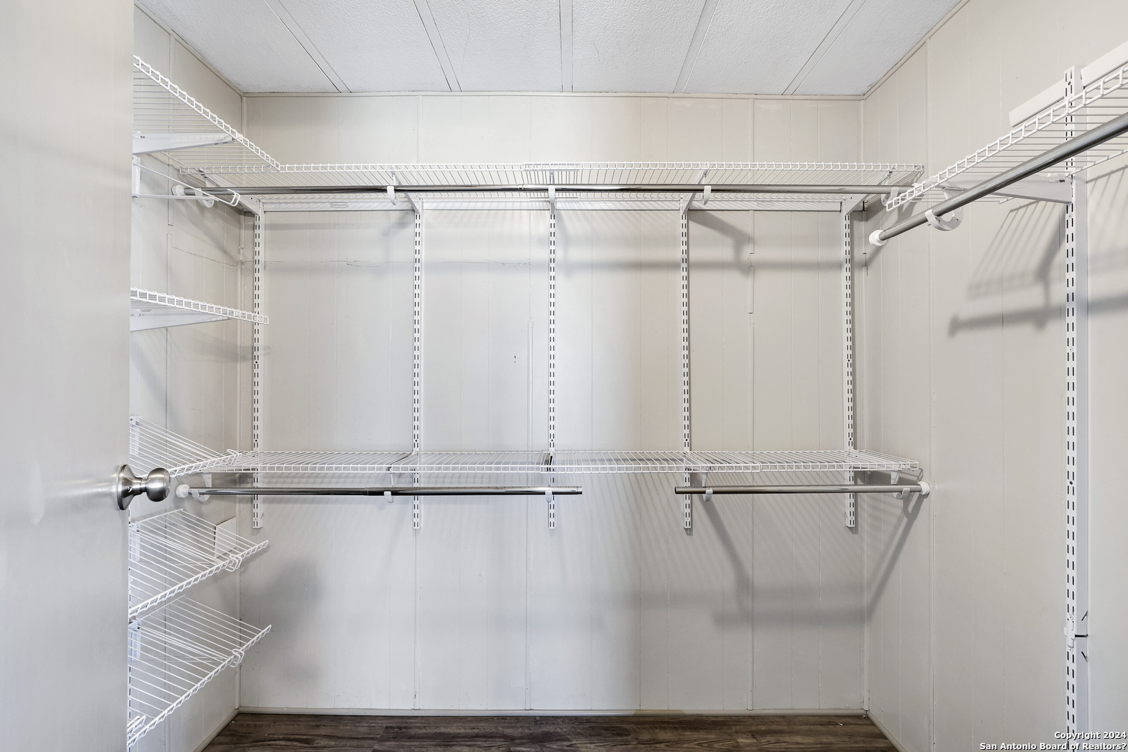 18066 La Gloria Road Elmendorf, TX 78112 - Photo 18 of 24 a view of a room with racks on the wall