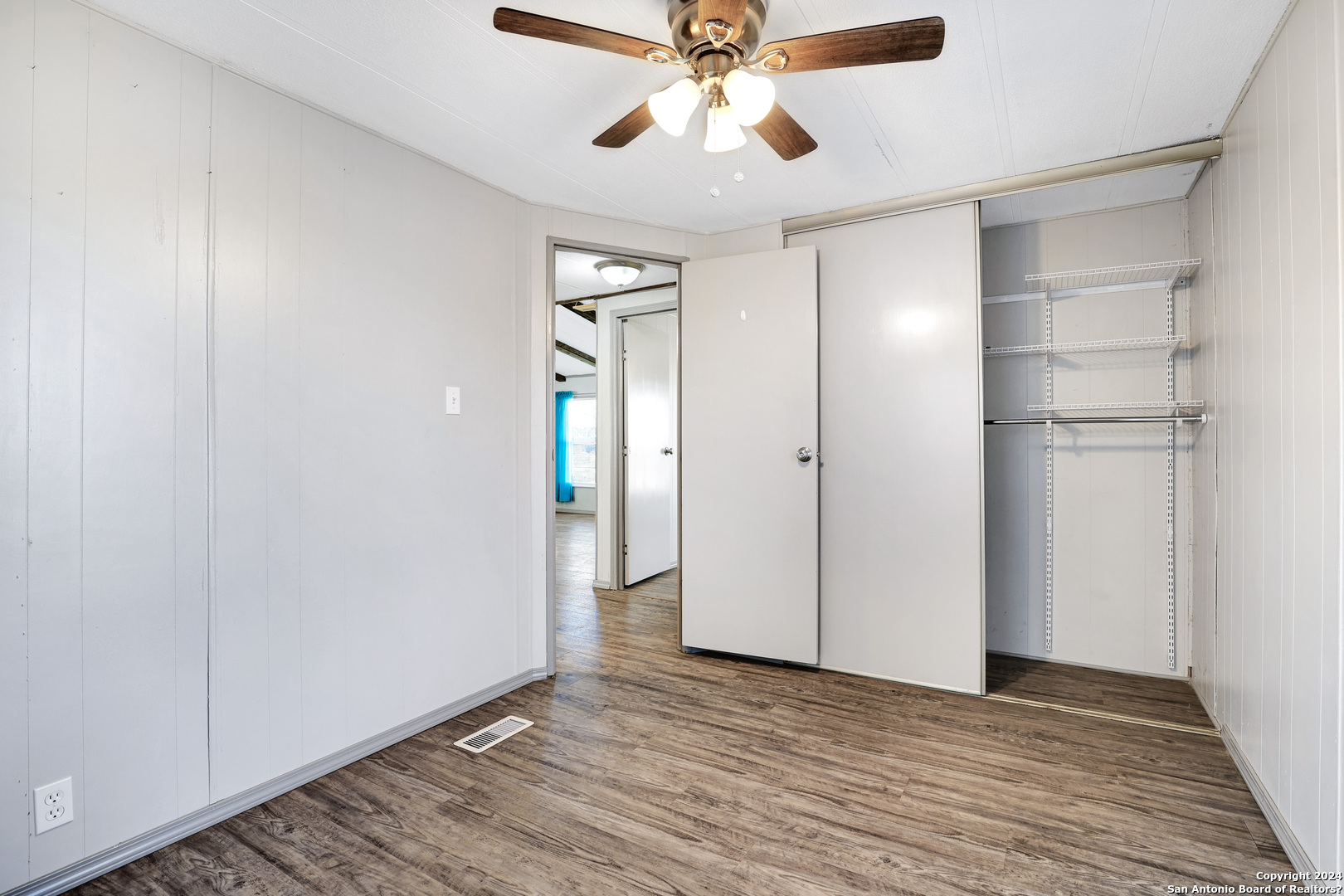 18066 La Gloria Road Elmendorf, TX 78112 - Photo 23 of 24 a view of an empty room and wooden floor